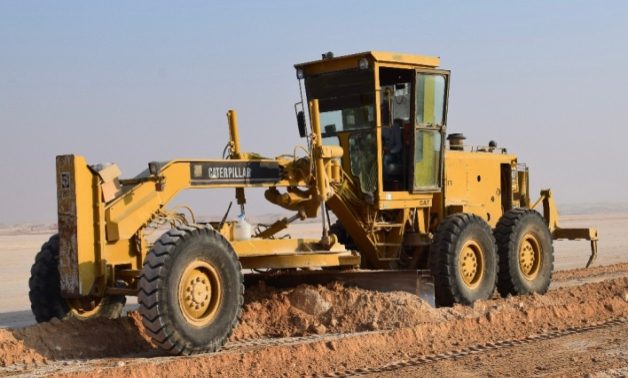 Motor grader forming a road